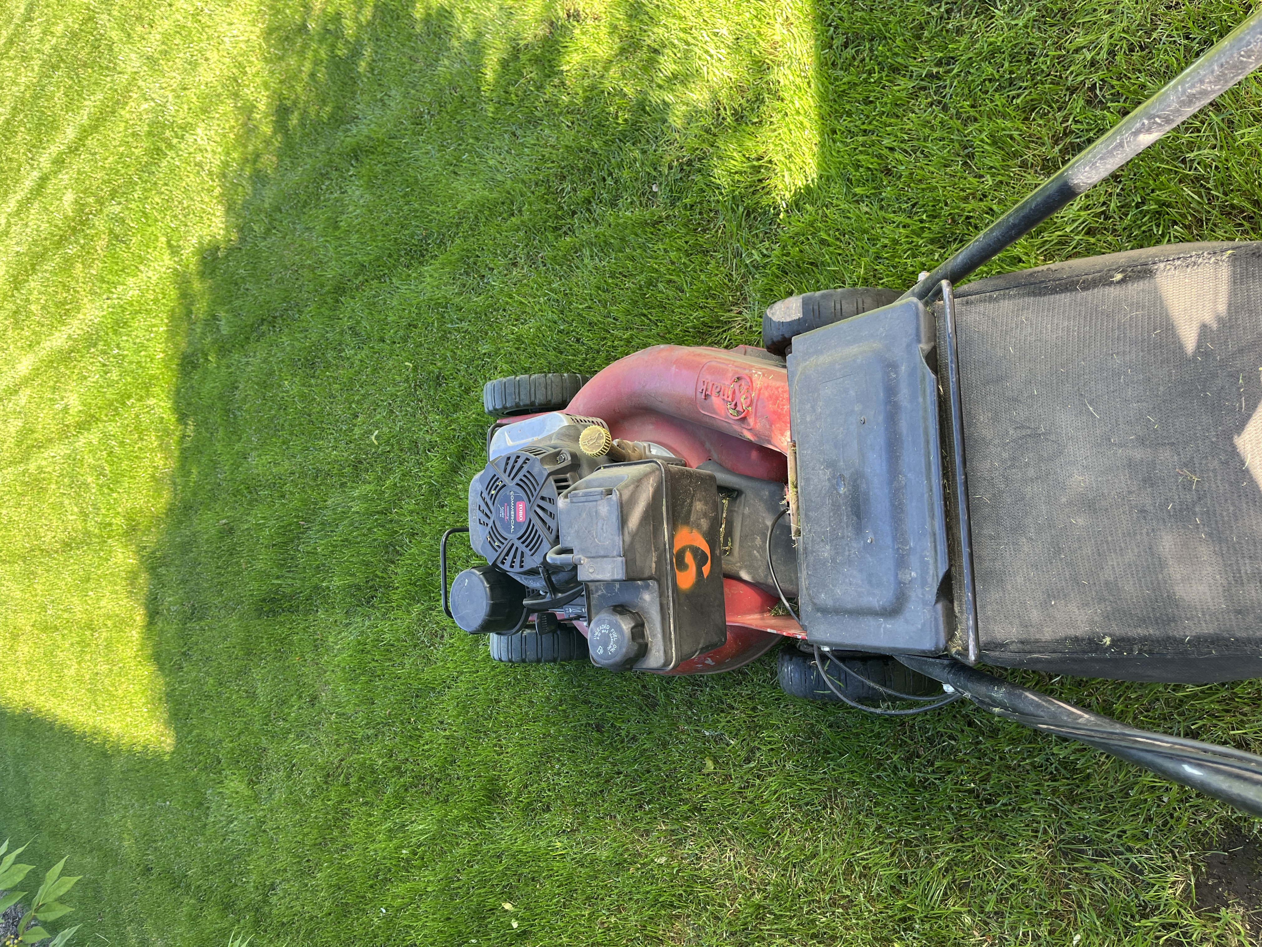 Spruce Lawn Care team member mowing a residential lawn in Spokane Valley
